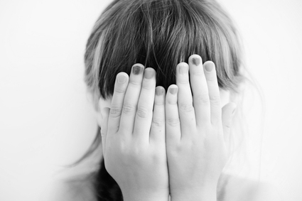 Little girl with hands covering her eyes